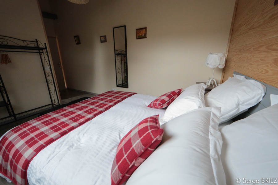 La chambre Lot lit champêtre rouge et blanc.